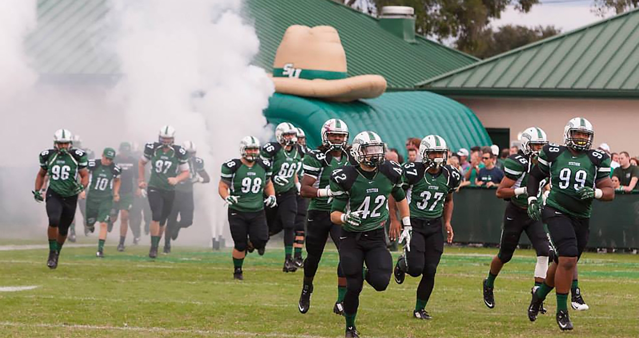 football team running onto the field