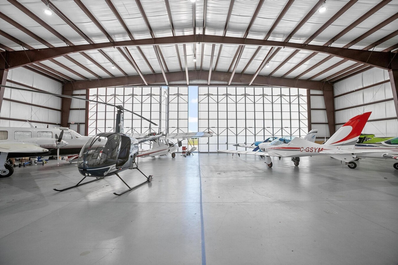 hangar with planes and helicopter